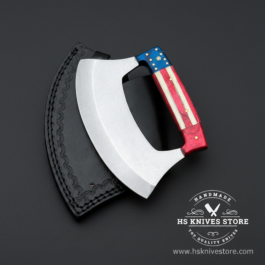 D2 steel ulu knife with American flag handle and black embossed leather sheath on dark charcoal studio background facing right