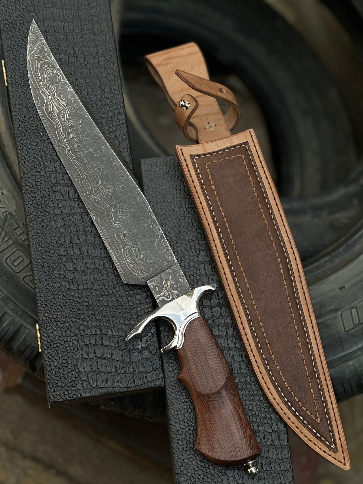 Handmade Damascus steel Bowie knife with long wavy Damascus blade crescent hawk-bill guard rosewood handle and brown leather sheath with belt loop