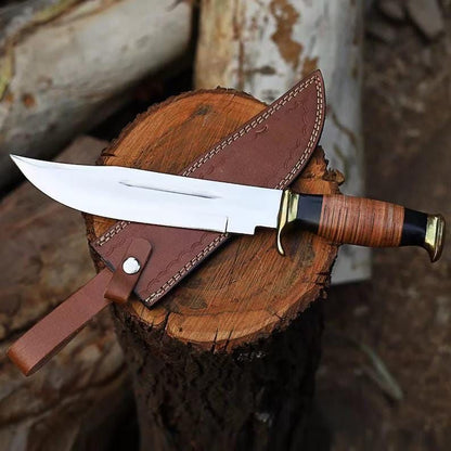 Handmade D2 steel American classic Bowie knife with stacked leather handle and embossed leather sheath on wood stump, original product photo