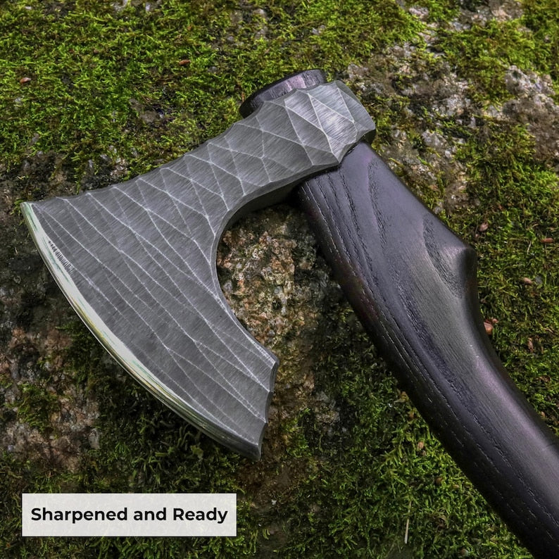 Axes with a textured blade and wooden handle on a mossy stone background