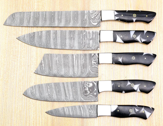 Set of six Damascus steel kitchen knives on a wooden surface