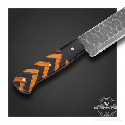 Close-up of the black and orange chevron wood-resin handle with pins on a Damascus slicer
