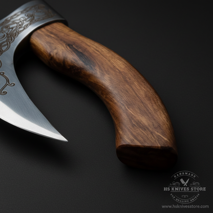 Close-up macro of natural walnut wood handle with warm reddish brown grain on Viking pizza axe
