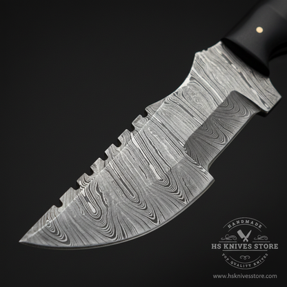 Close-up macro of Damascus steel tracker blade showing bold flowing ladder wood grain Damascus pattern and thick spine and sharp edge