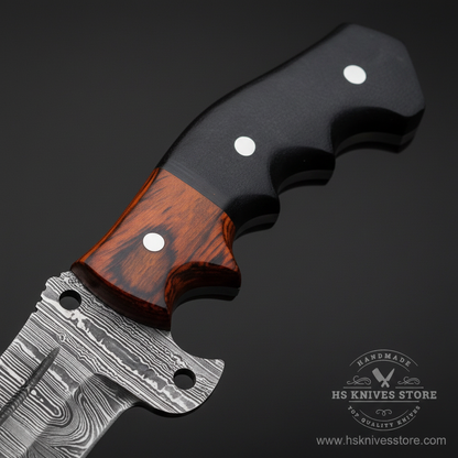 Close-up macro of two-tone handle with dark black micarta top and warm reddish-brown pakkawood bottom and two silver rivets and Damascus guard