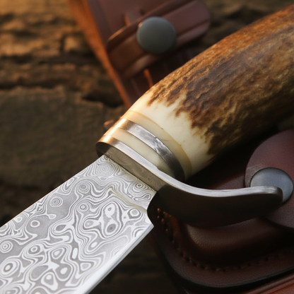 Extreme macro close-up of stag antler handle and polished steel guard bolster on Damascus hunting knife natural texture