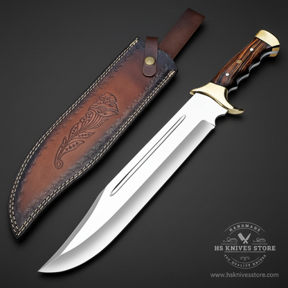 D2 steel Bowie knife dark rosewood handle large brass bolster mirror polished blade dark brown floral leather sheath dark charcoal studio background