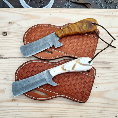 Front view of a two-piece custom Damascus Bull Cutter Knife set with epoxy resin handles and leather sheaths