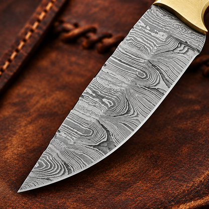Close-up of the flowing hand-forged Damascus Steel pattern on the Cowboy Champion knife blade