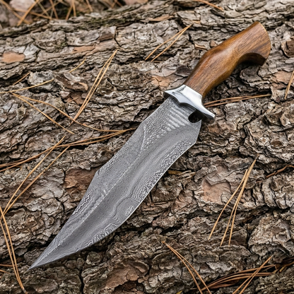 Right-angle view of hand-forged Damascus Bowie on natural bark