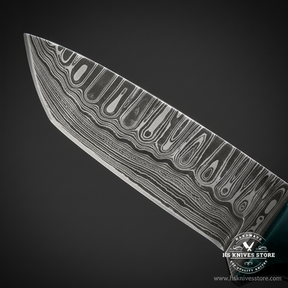 Macro close-up of Damascus steel tanto skinner knife blade showing bold wavy flowing Damascus pattern and angled tanto tip