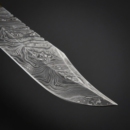 Damascus steel blade close-up showing natural layered folded pattern and sharp clip point edge