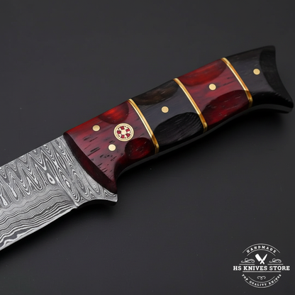 Macro view of red and black buffalo horn handle with alternating segments brass spacers decorative brass medallion and pins on Damascus hunting knife