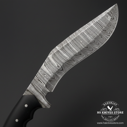 Macro close-up of Damascus Kukri knife curved blade showing bold swirling flowing Damascus pattern dark etched finish and polished edge