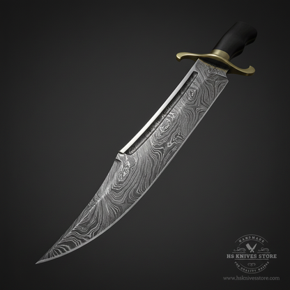 Close-up macro of Damascus steel Bowie knife blade showing swirling layered Damascus pattern and fuller groove