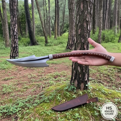 One-hand outdoor presentation of a curved fantasy Naga collector spear with leather sheath