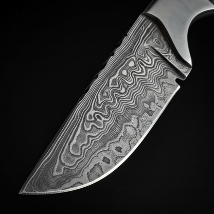 Damascus steel skinner knife blade edge and spine drop point close-up