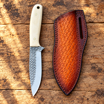 Front view of Cowboy Bush Knife with 3.6-inch Rasp Steel blade, pale deer bone handle and matching brown leather sheath