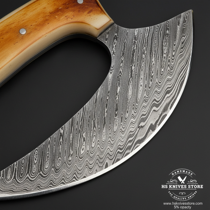 Macro close-up of Damascus steel ulu knife wide crescent blade showing bold wavy flowing pattern and steel bolster detail