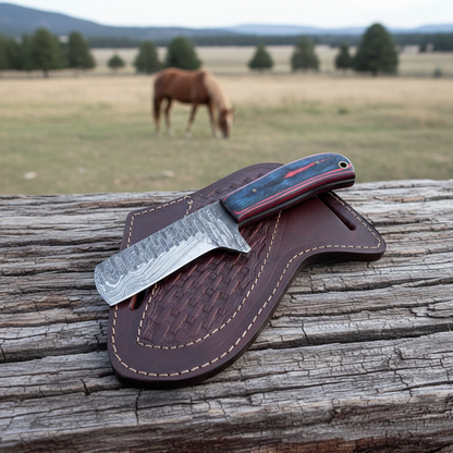 Damascus cowboy knife and pancake leather sheath on a ranch fence with a horse behind