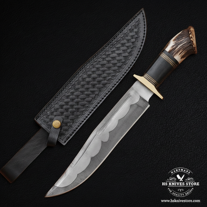 Hand forged Bowie knife with elk antler handle and black basket weave leather sheath mirror view on dark charcoal background
