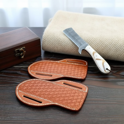 Two-piece handmade Damascus Bull Cutter Knife set with epoxy handles and leather sheaths in a collector display
