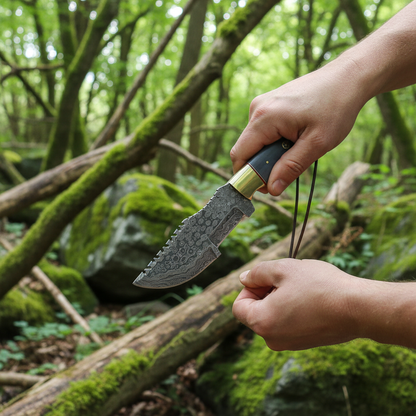 Hunter hands holding Damascus tracker knife with blue bone handle outdoor forest lifestyle action shot