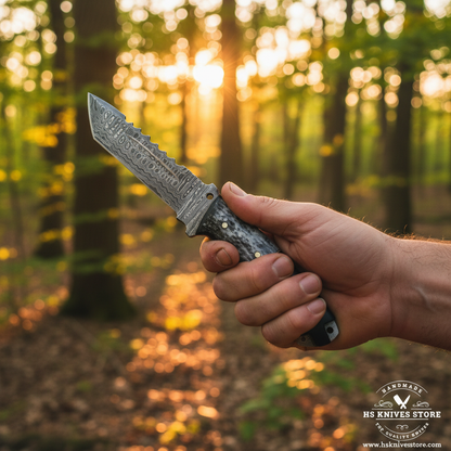 One hand gripping Damascus tanto skinner knife with black micarta bone spacer handle in outdoor forest golden hour lifestyle setting