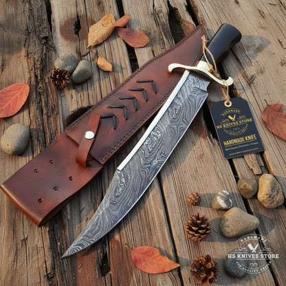 Damascus steel large Bowie knife flat lay on dark rustic wood with HS Knives Store hang tag attached to handle autumn leaves