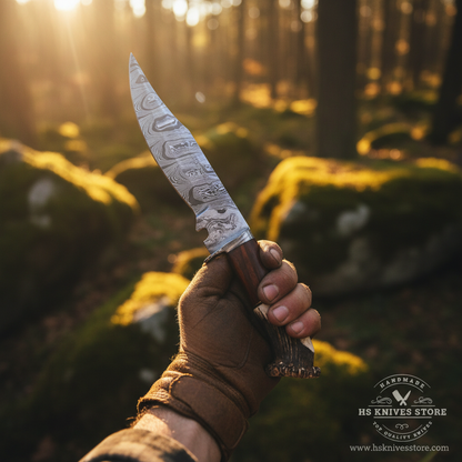 Hunter hand gripping stag crown handle Damascus steel Bowie knife in action pose outdoor forest with golden sunlight