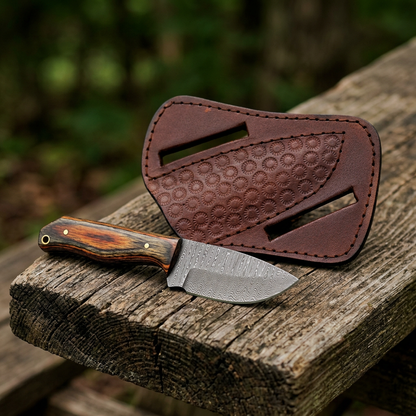 Right-angle view of multitone-handled mini knife and floral sheath on a picnic bench