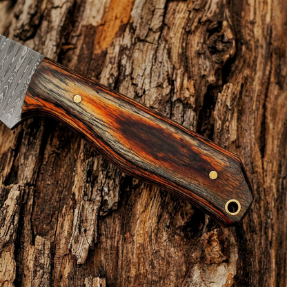 Handle macro showing orange-brown streaks, two pins and lanyard opening