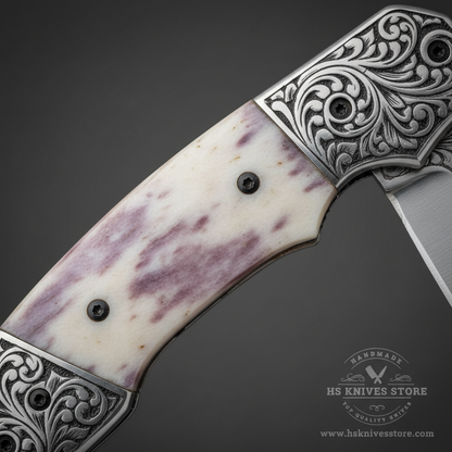 Close-up macro of natural camel bone handle scales with cream white surface and natural purple-pink mottled grain and three black pin rivets