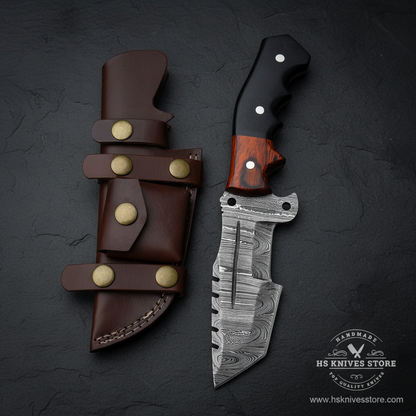 Vertical luxury shot of Damascus steel tracker knife two-tone micarta handle on dark slate background with dark chocolate brown leather sheath