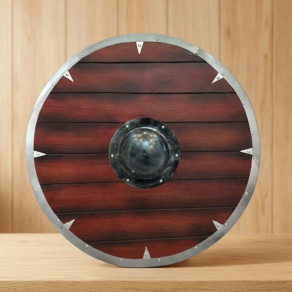 Handmade Viking round shield with dark wood planks and metallic-look rim on a timber table