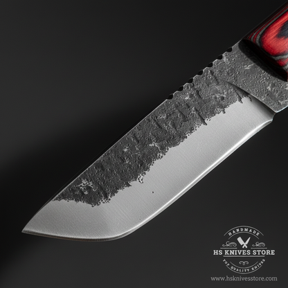 Macro close-up of carbon steel drop point skinner knife blade showing dark stonewashed finish serrated spine section and curved belly