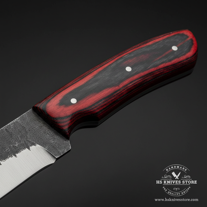 Macro close-up of two-tone dark red burgundy and black layered pakkawood handle showing smooth polished finish and steel pins