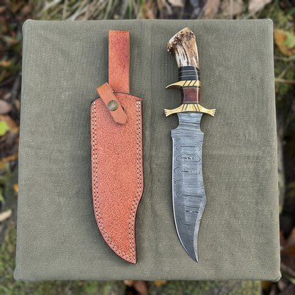 Overhead display of 14.5-inch Damascus Bowie and separate sheath on camp canvas