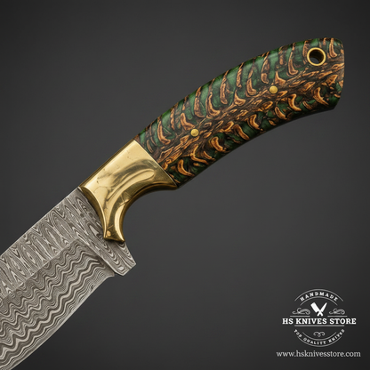 Close-up of the stabilized green pinecone resin handle with brass guard and lanyard hole