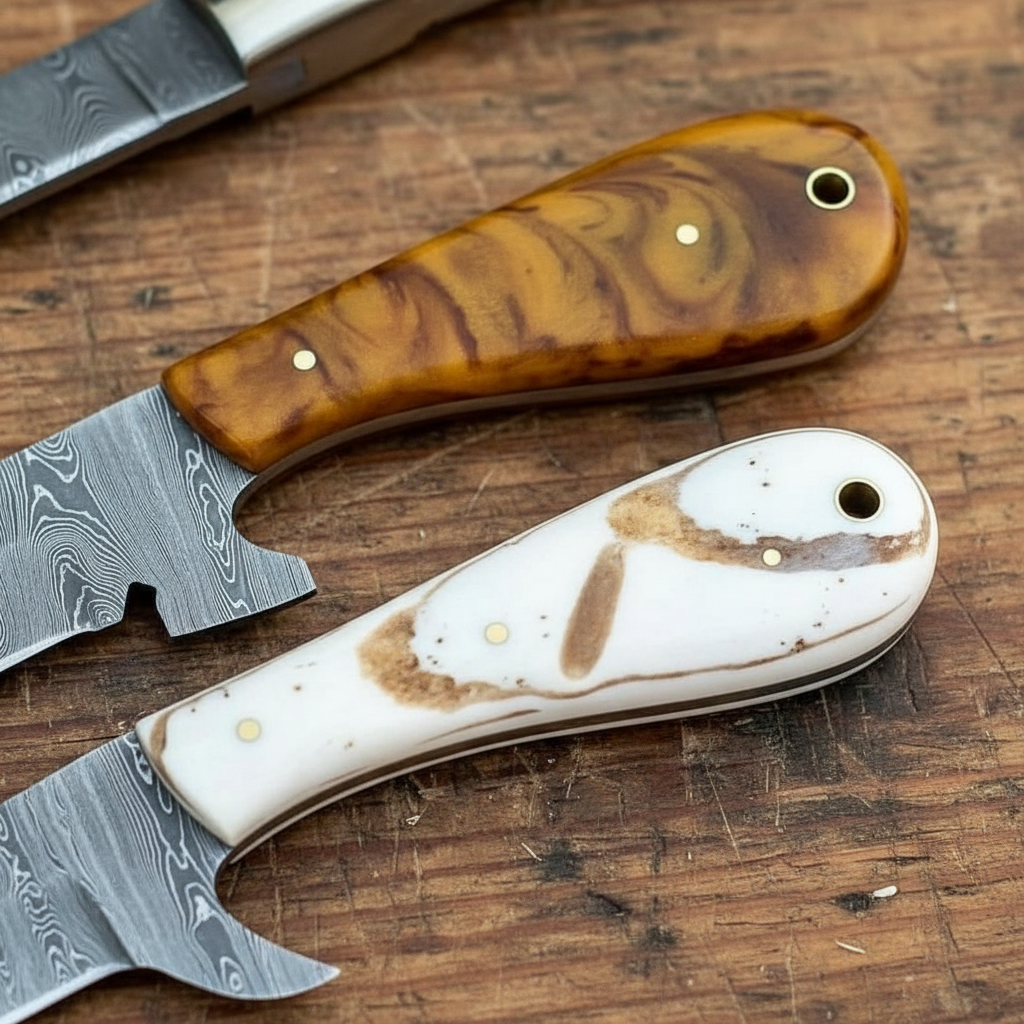 Macro view of the distinct amber and pale epoxy resin handles on a custom Damascus knife set