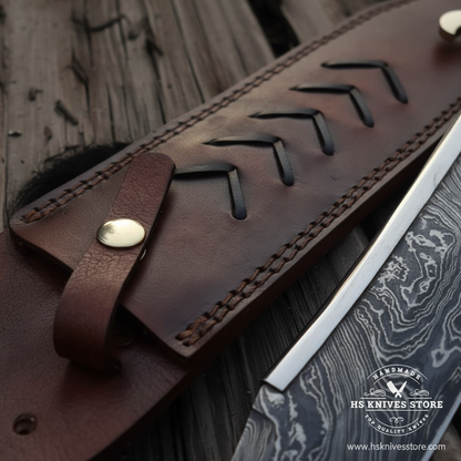 Close-up macro of dark brown chevron arrow tooled leather sheath with snap strap and brass rivet for Damascus Bowie knife