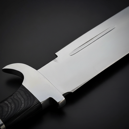 Close-up macro of D2 steel large Bowie blade showing polished mirror finish false edge and clip point detail