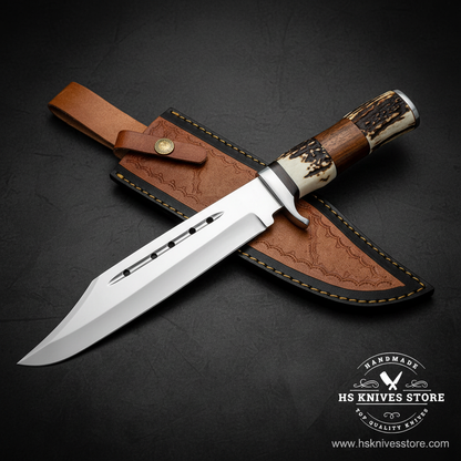 D2 steel Bowie knife with stag horn wood handle and two-tone leather sheath on dark charcoal background studio shot