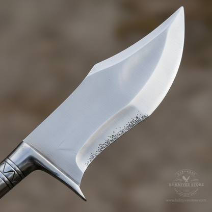 Macro view of the broad satin high carbon steel spearhead with integrated guard