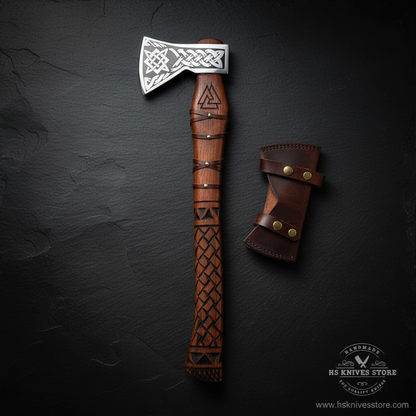 Vertical luxury shot of handmade Viking axe Celtic knot etched head carved rosewood handle on dark slate background with leather sheath