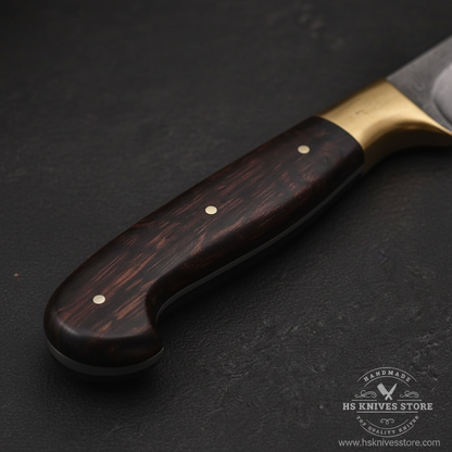 Close-up macro of dark rosewood handle with finger notch two silver dot rivets and solid brass bolster guard on Damascus fillet knife