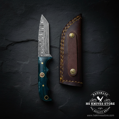 Damascus tanto skinner knife with teal bone handle displayed vertically on dark slate luxury studio background