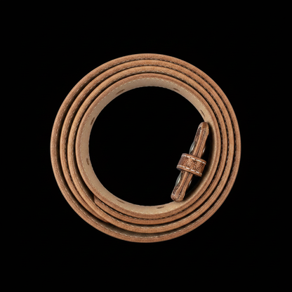 Hand-tooled western leather belt basket weave engraving coiled black background studio shot