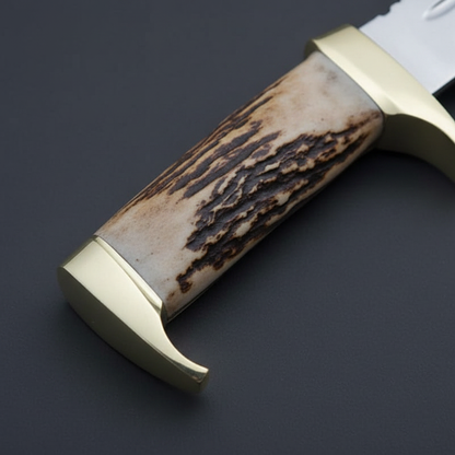 Close-up macro of genuine stag antler handle with natural texture and solid brass guard with quillon