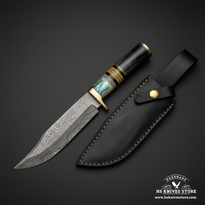 Damascus Bowie knife with abalone resin spacer horn handle and black leather sheath mirror view on dark charcoal background